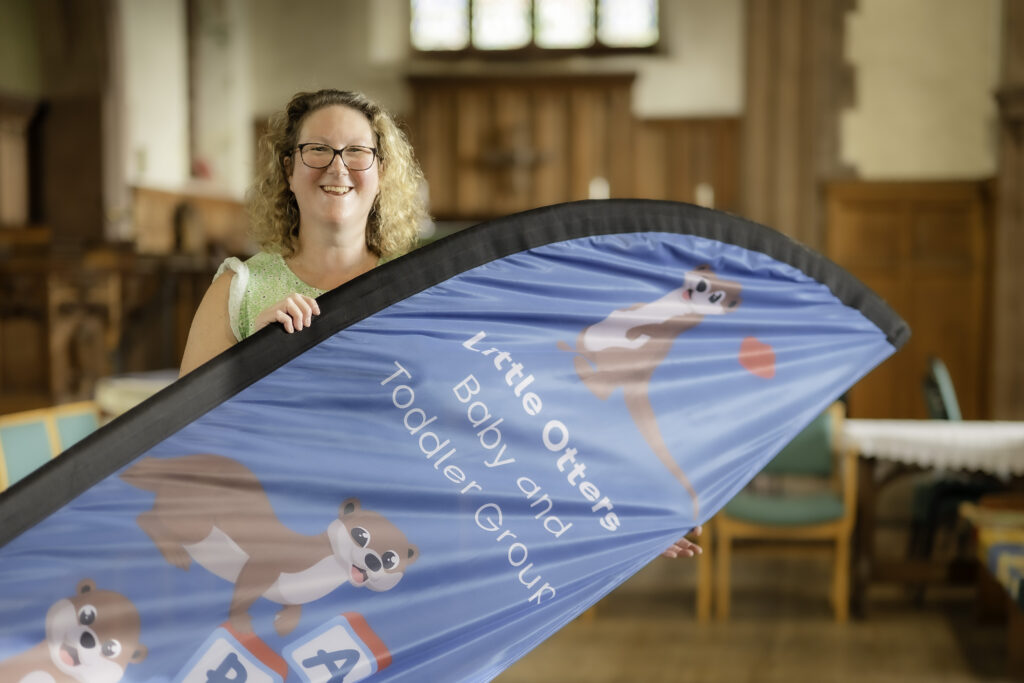 Woman standing holding a banner at a toddler group