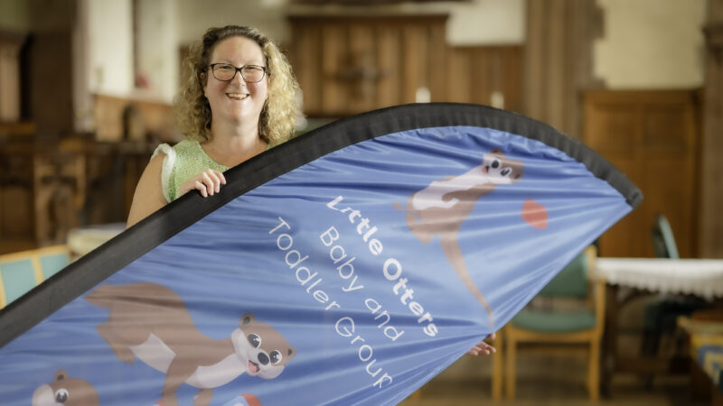 Woman standing holding a banner at a toddler group